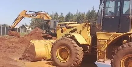 Wheel loader with excavator behind